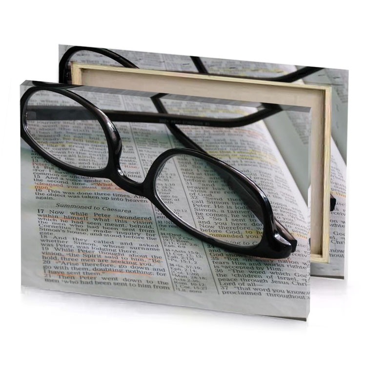 a pair of glasses resting on bible camouflage green canvas