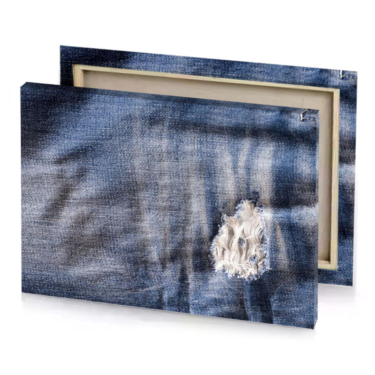 a pair of jeans with holes and hole in the slate gray canvas