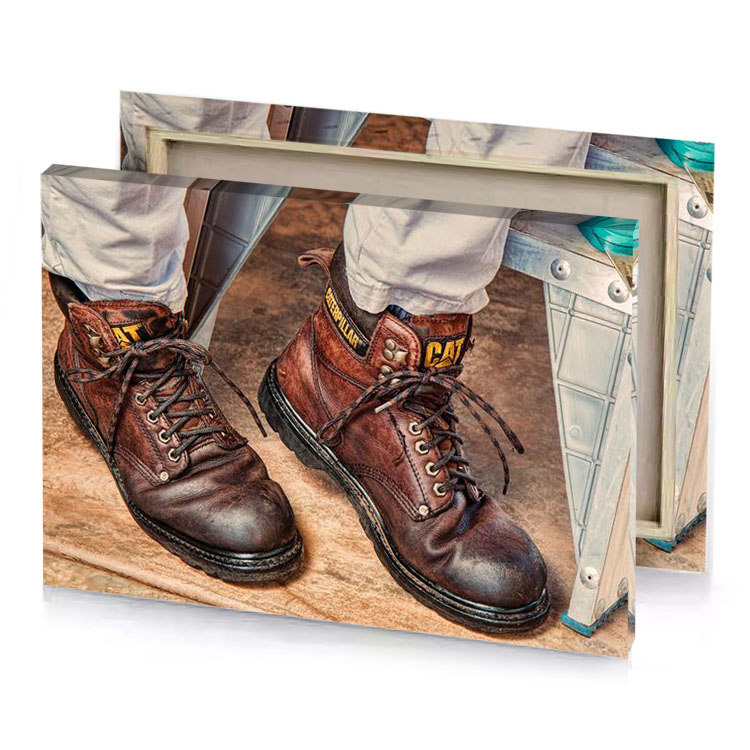 a pair of work boots on man s feet silver canvas
