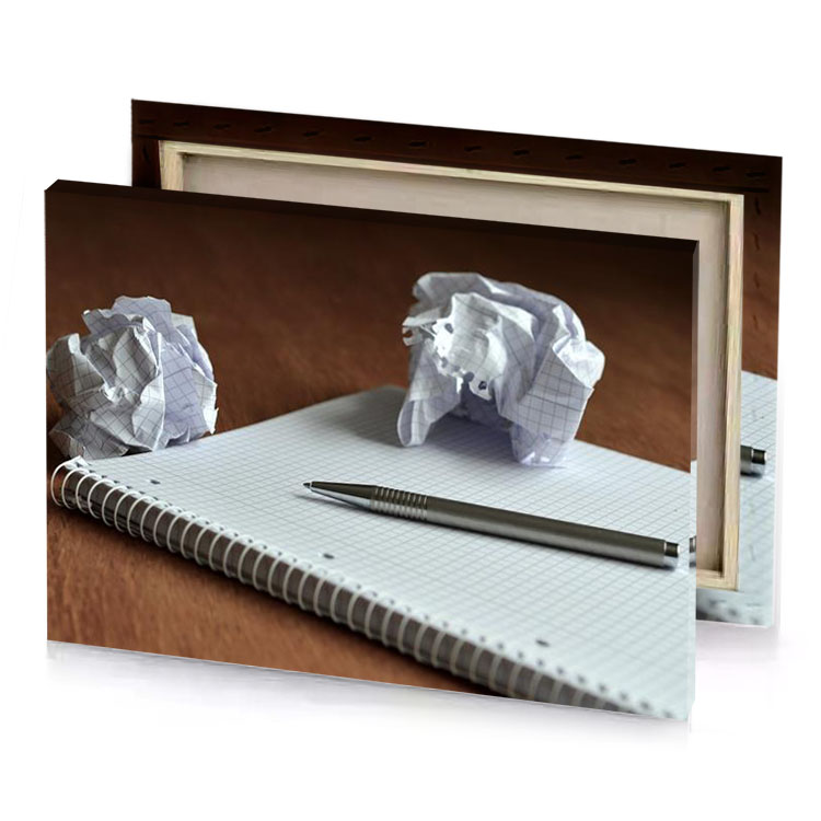 a pen and notebook on table silver canvas