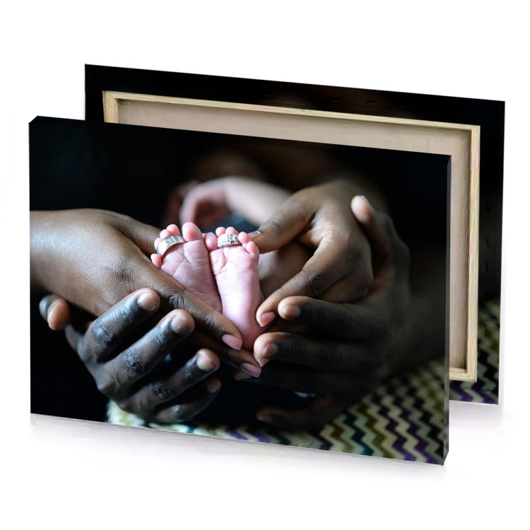 a person holding baby in their hands gray canvas