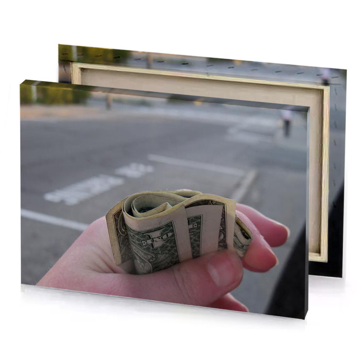 a person holding dollar bill in their hand gray canvas
