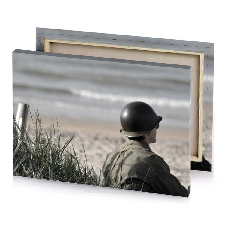 a person in helmet sitting on beach smoky black canvas
