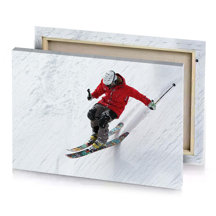 a person in red jacket skiing down hill burgundy canvas