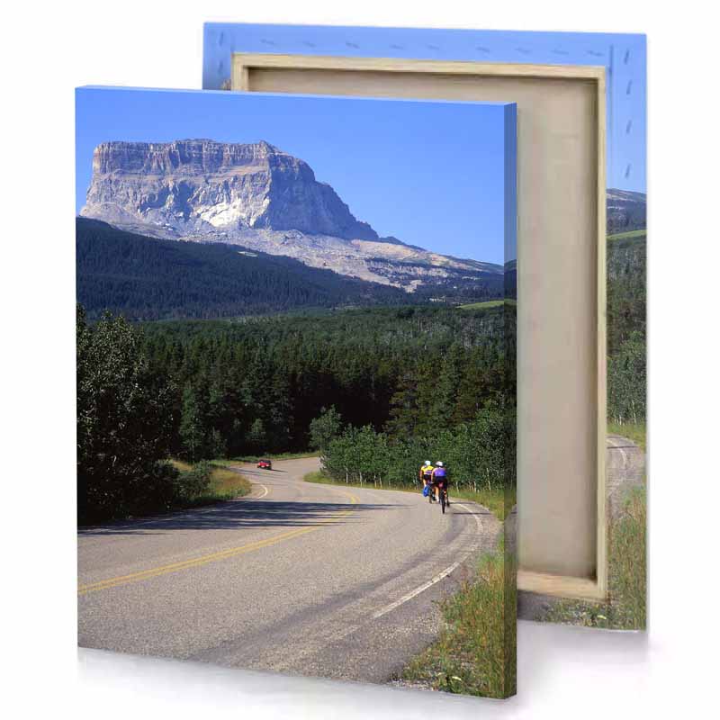 a person riding bike down road charcoal canvas