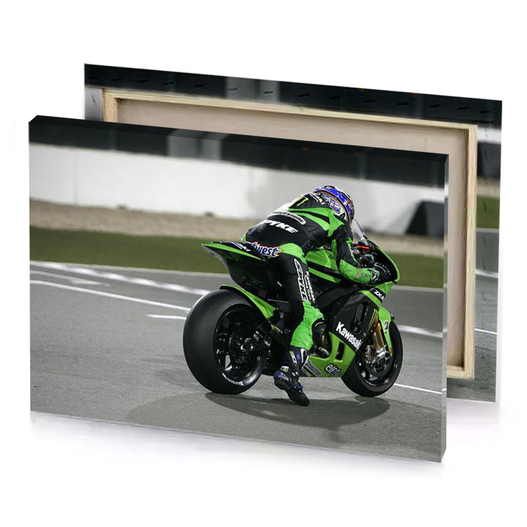 a person riding green motorcycle on race track smoky black canvas