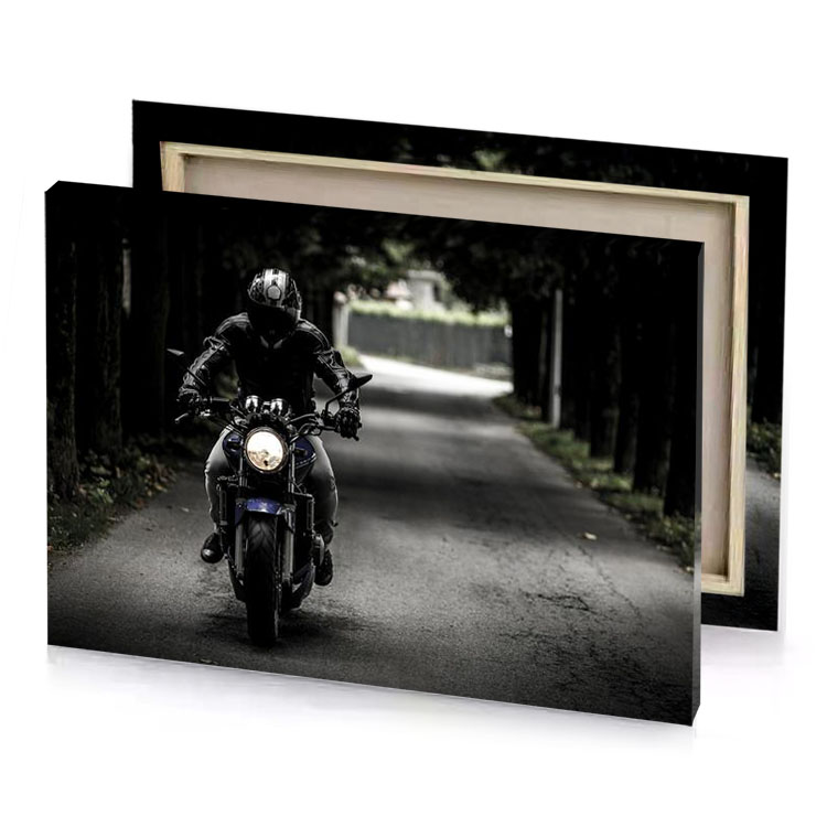 a person riding motorcycle down road camouflage green canvas