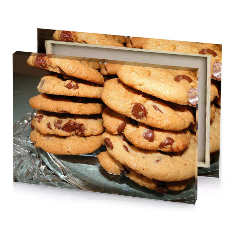 a pile of chocolate chip cookies on glass plate sand brown canvas