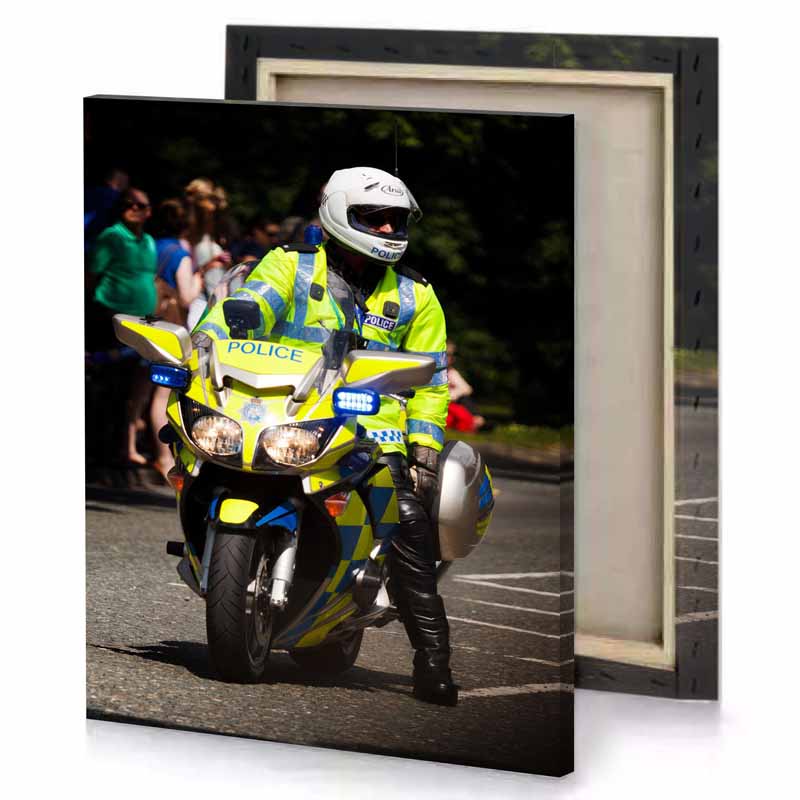 a police officer riding motorcycle down street khaki canvas