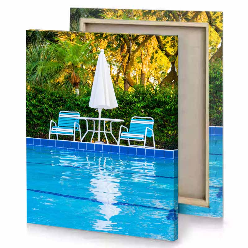 a pool with two chairs and an umbrella cobalt blue canvas