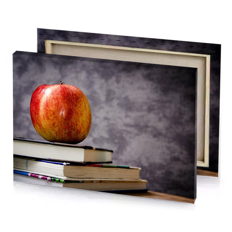 a red apple sitting on top of stack books gray canvas