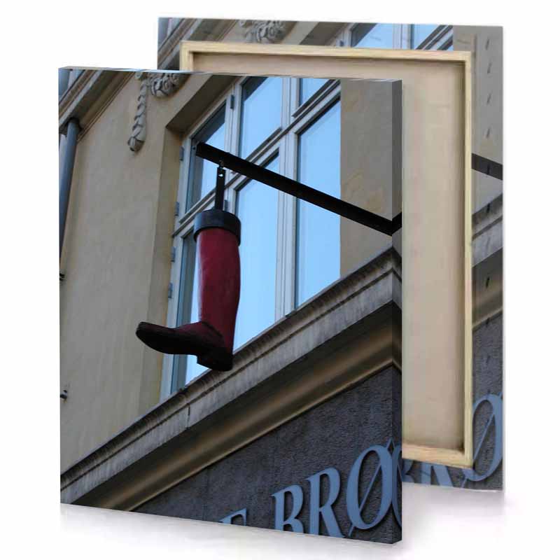 a red fire hydrant hanging from building light steel blue canvas