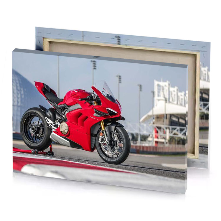 a red motorcycle parked on race track spanish canvas