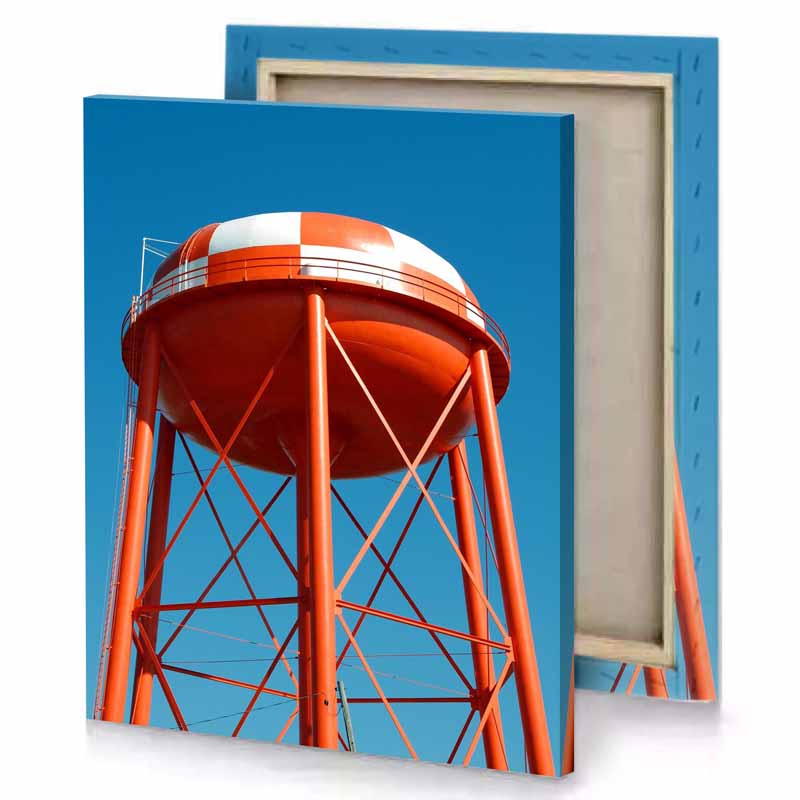 a red water tower with blue sky in the background maroon canvas