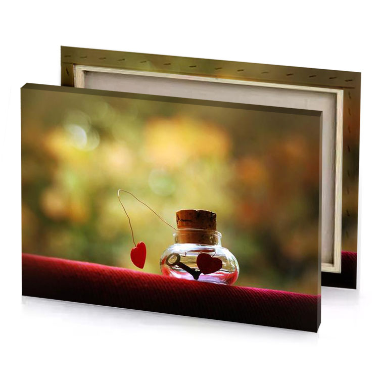 a small bottle with heart inside sitting on red couch dark khaki canvas