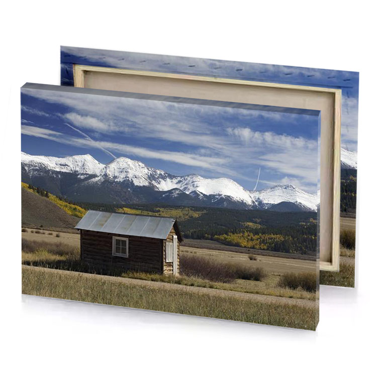 a small cabin in field with mountains the background manatee canvas