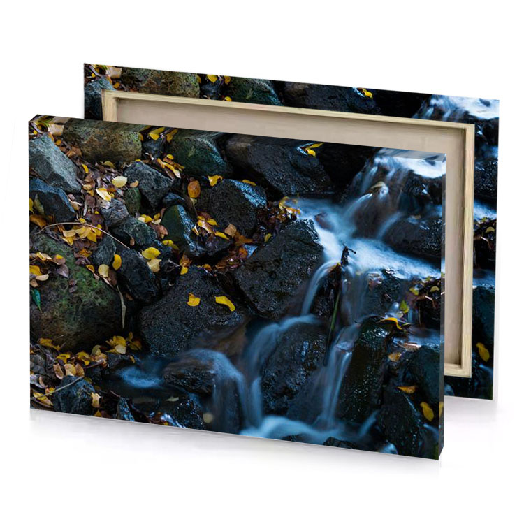 a stream of water running through rocky area charcoal canvas