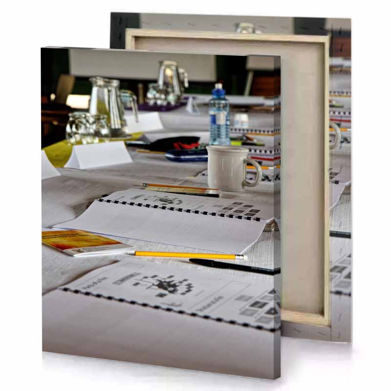 a table with bunch of papers and cup coffee silver canvas
