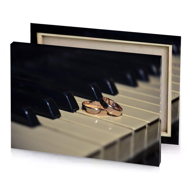 a wedding ring sitting on top of piano rosy brown canvas