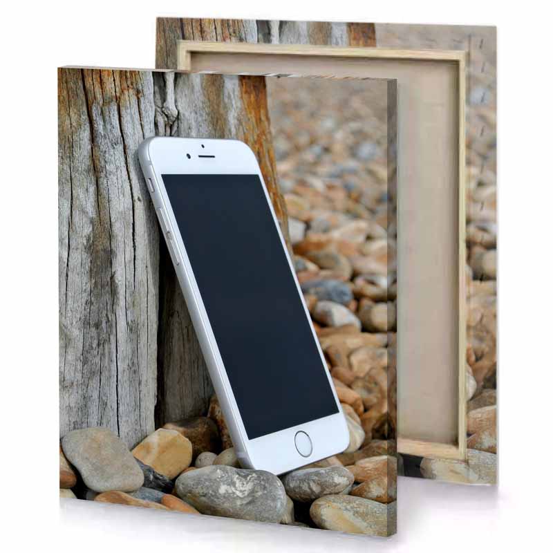 a white cell phone sitting on rock bistre canvas
