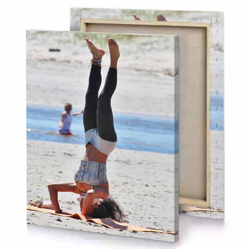 a woman doing handstant on the beach light steel blue canvas