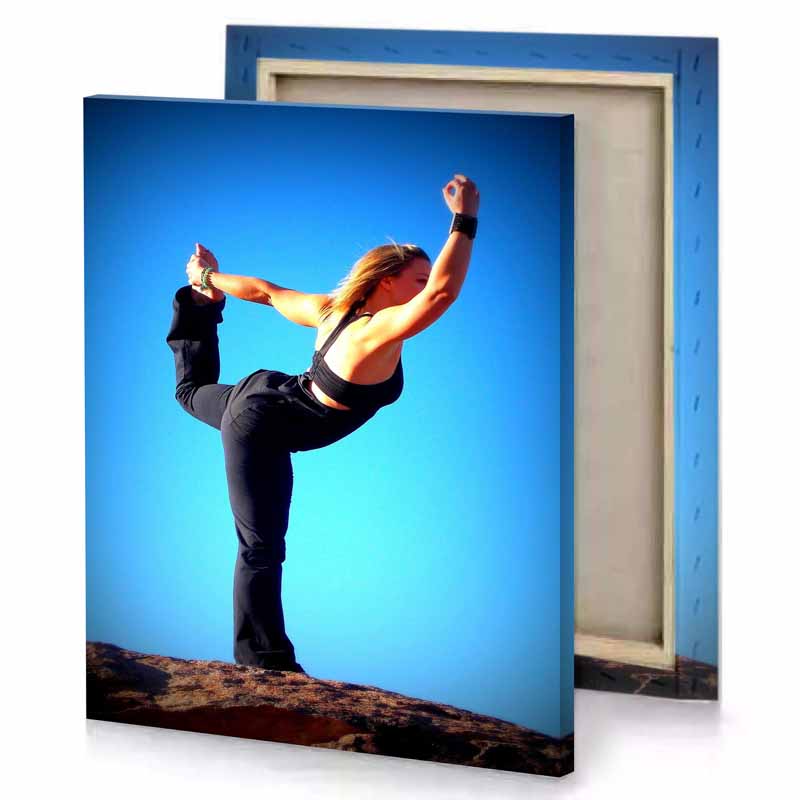 a woman doing yoga pose on rock aquamarine canvas