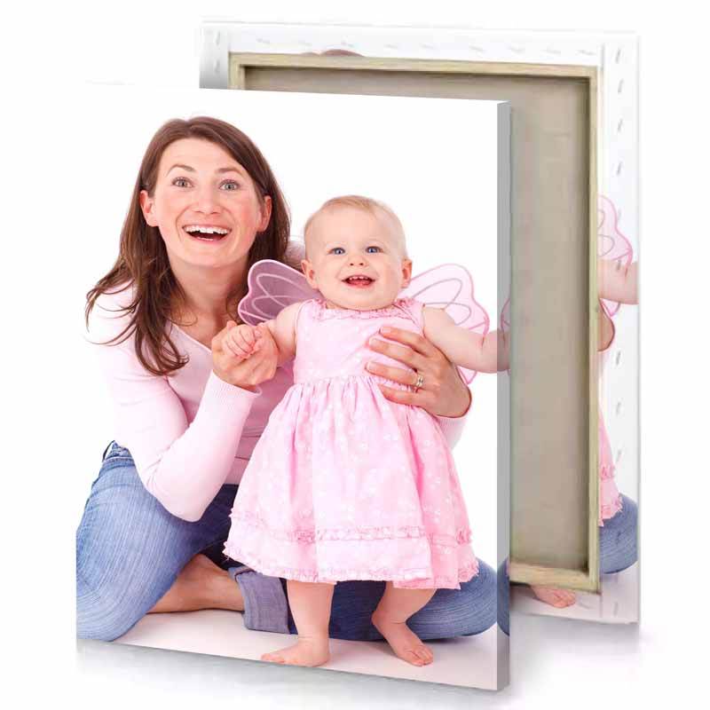 a woman holding baby in her arms snow canvas