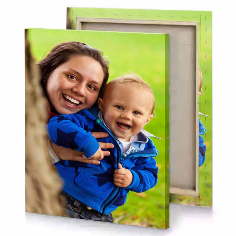 a woman holding baby yellow green canvas