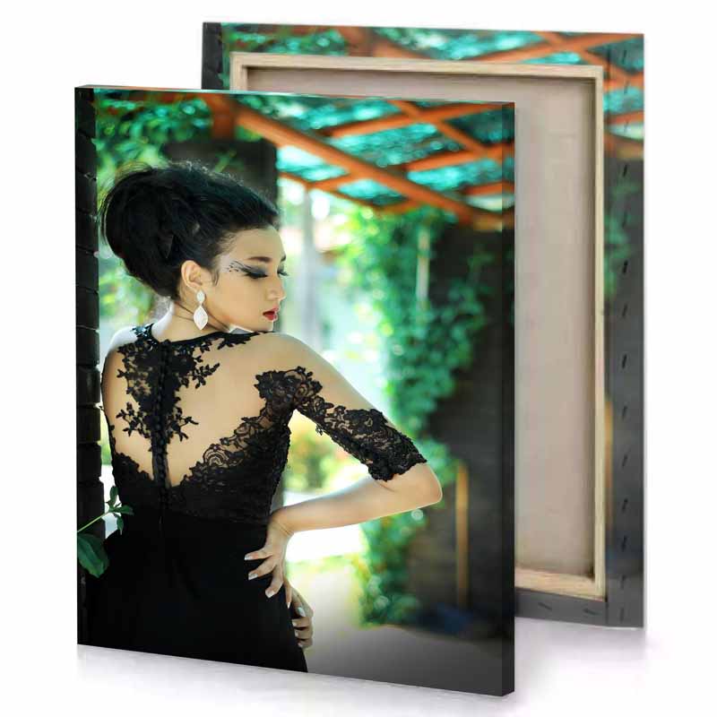a woman in black dress standing next to brick wall smoky canvas