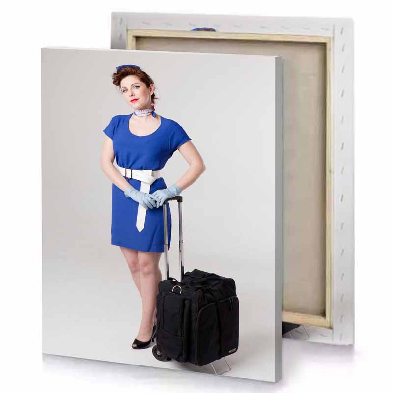 a woman in blue dress and gloves with suitcase gainsboro canvas
