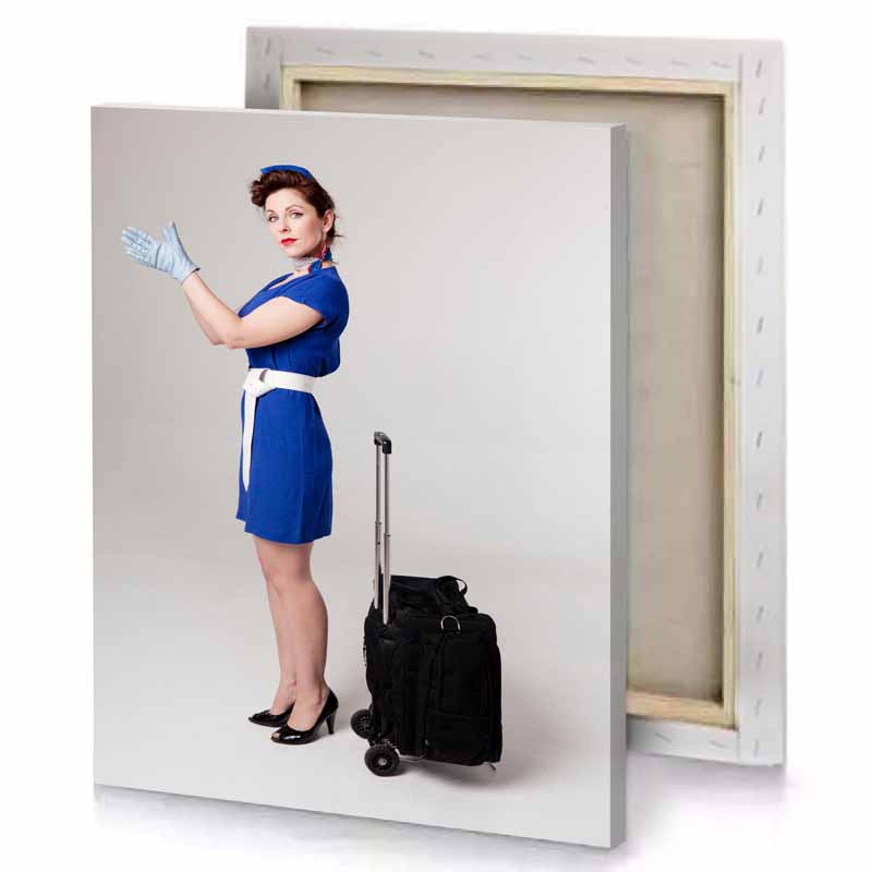 a woman in blue dress and hat with suitcase silver canvas