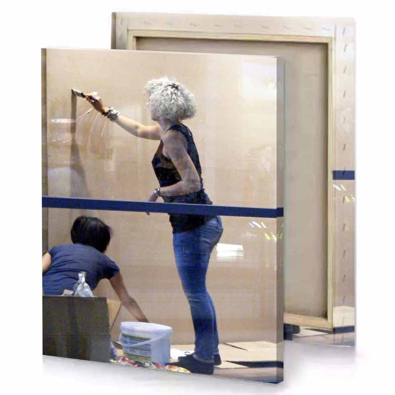 a woman is painting wall with brush rosy brown canvas