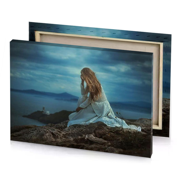 a woman sitting on rock looking out at the ocean teal blue canvas