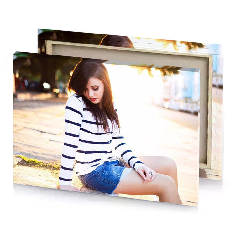 a woman sitting on the ground wearing striped sweater white smoke canvas