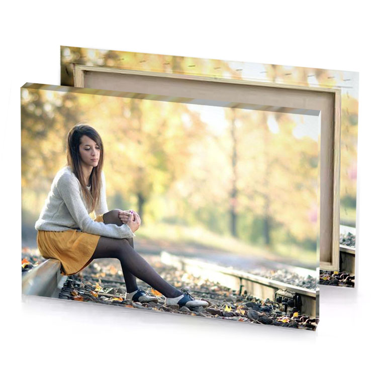 a woman sitting on train track with her phone champagne canvas