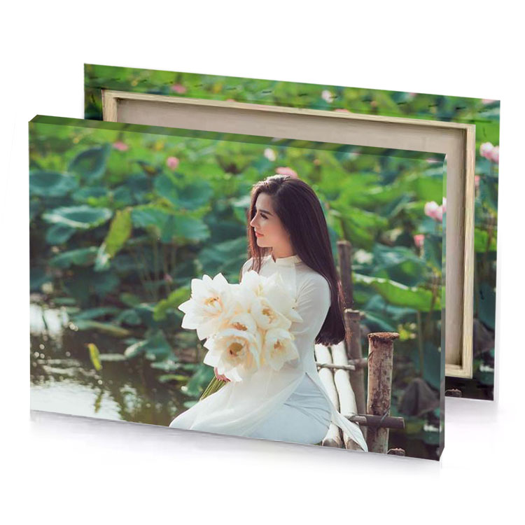 a woman sitting on wooden bridge with white flower in fern green canvas
