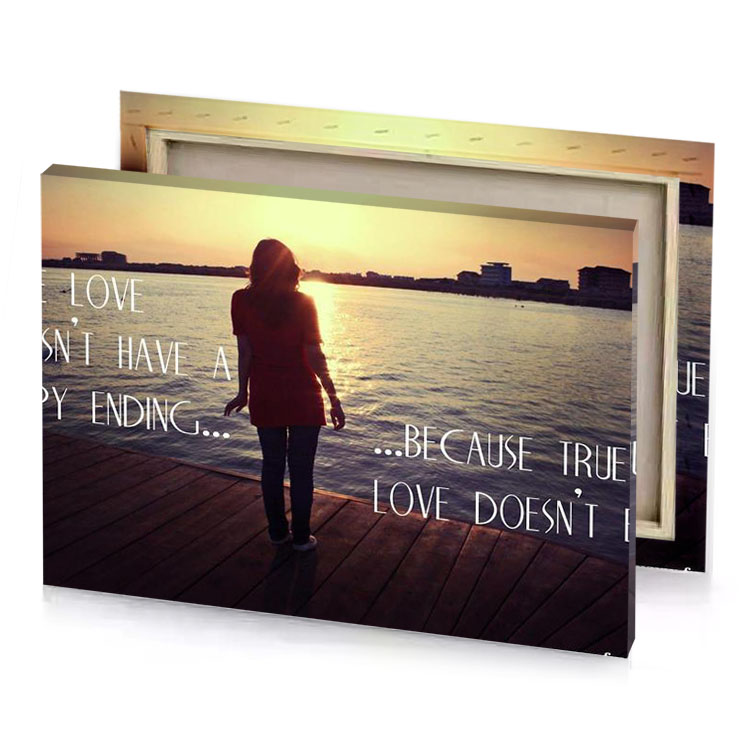 a woman standing on dock with the sun setting behind tan canvas
