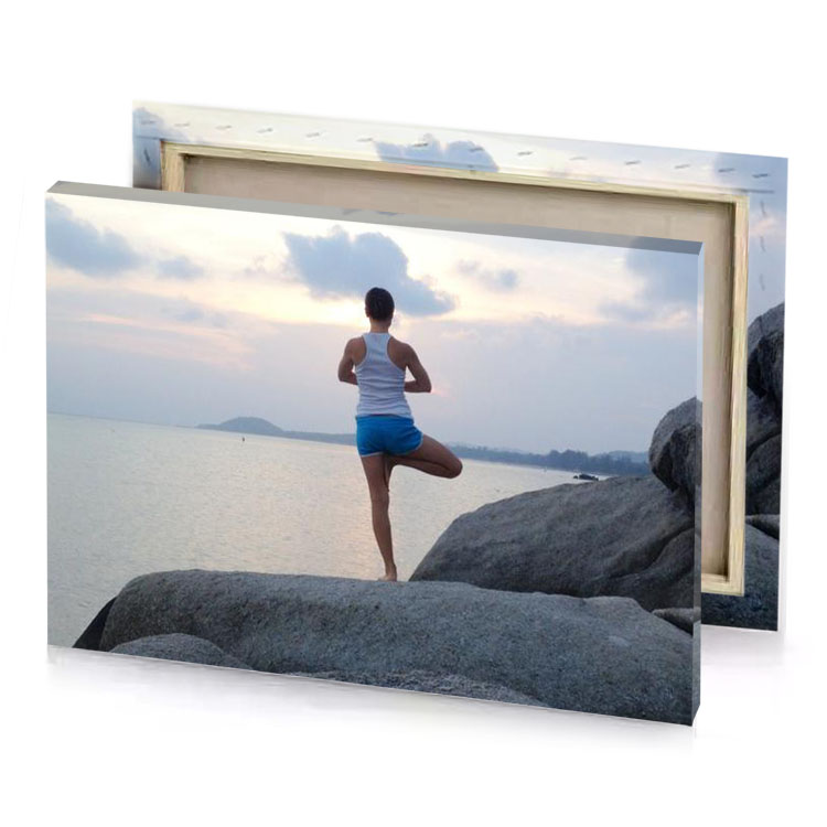 a woman standing on rock near the water silver canvas