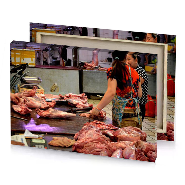 a woman standing over table with meat rosy brown canvas
