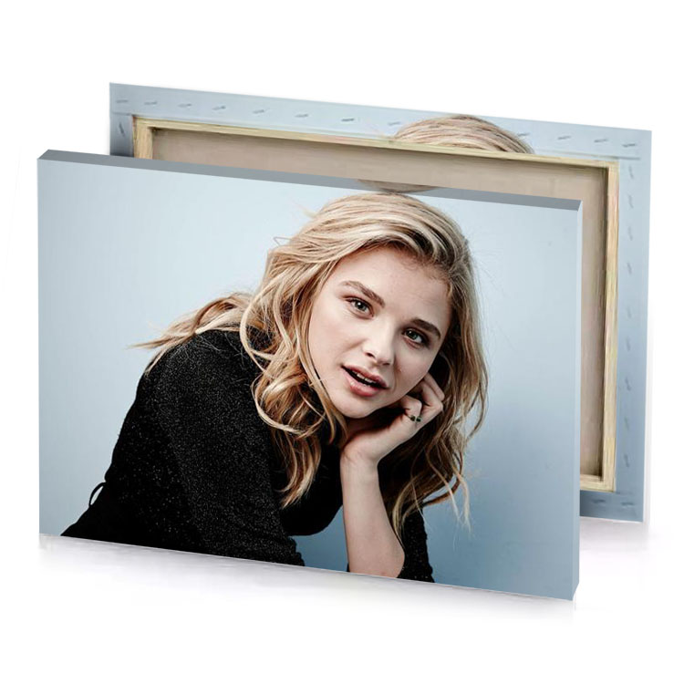 a woman with blonde hair and black top light steel blue canvas