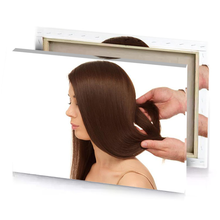 a woman with long brown hair is being styled by white canvas