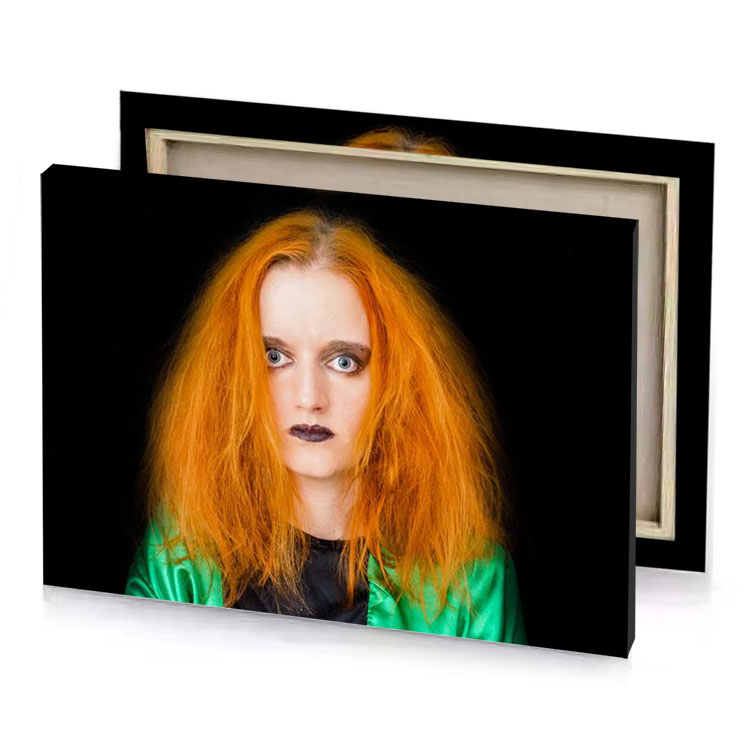a woman with red hair and green shirt black canvas