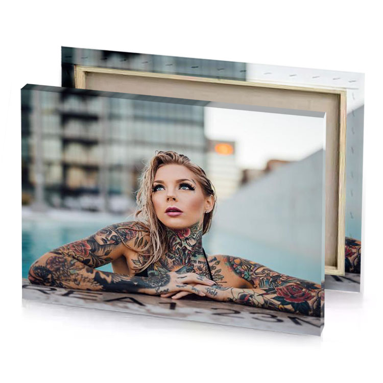 a woman with tattoos leaning on wall manatee canvas
