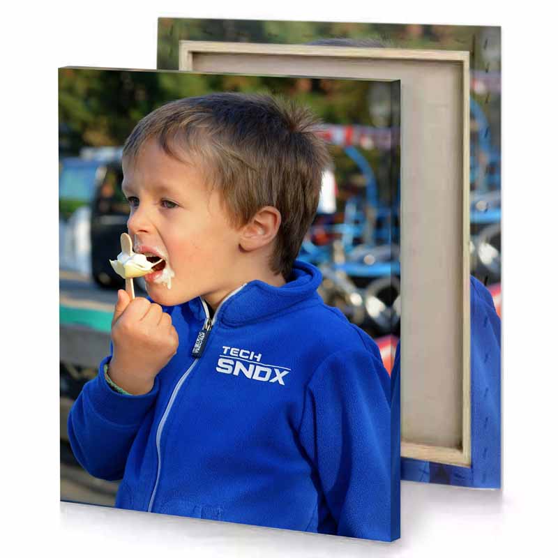 a young boy eating piece of cake cobalt blue canvas
