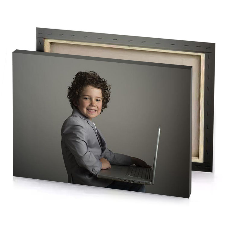 a young boy in suit sitting on laptop camouflage green canvas