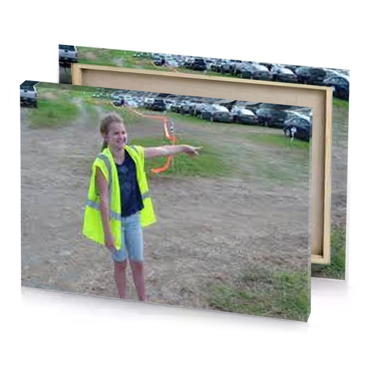 a young boy in yellow vest pointing at something dark khaki canvas