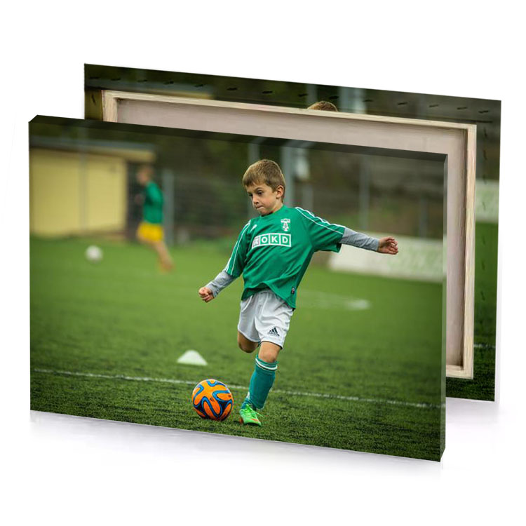 a young boy kicking soccer ball on field olive drab canvas