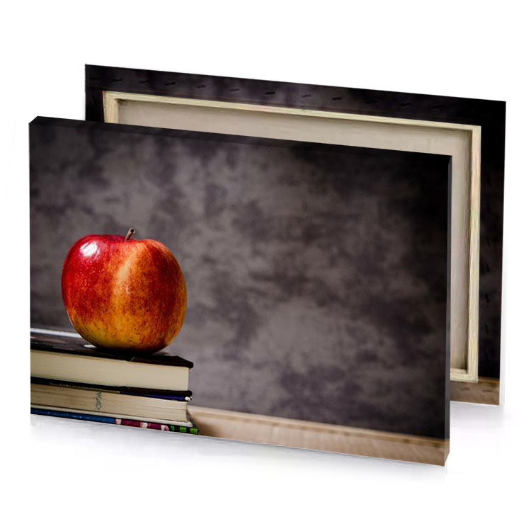 an apple sits on top of a stack books dim gray canvas