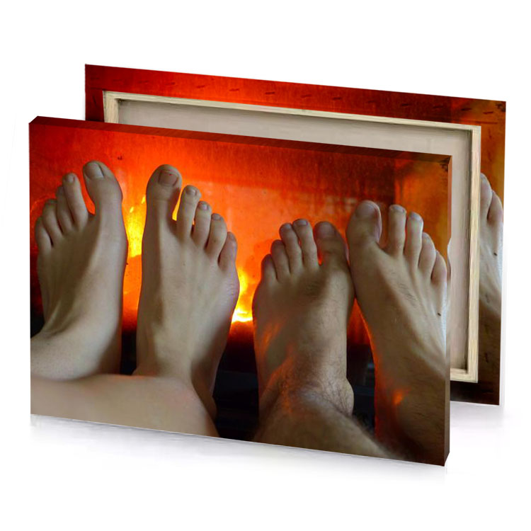feet in front of a fireplace flame canvas