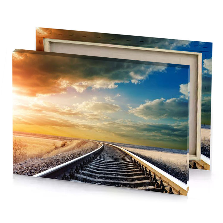railroad tracks in the winter with sun shining behind tan canvas